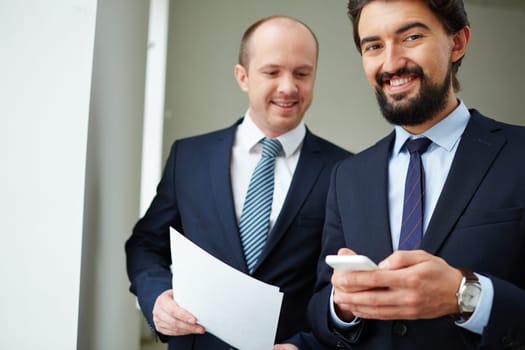 Two friendly businessmen in elegant suits