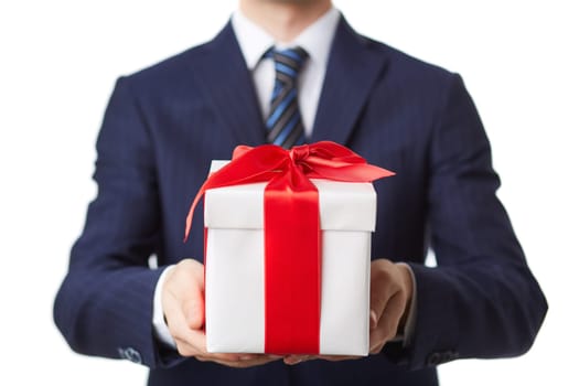 Businessman in suit holding giftbox tied by red ribbon