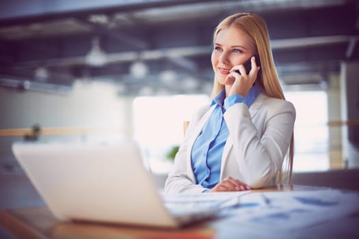 Young businesswoman talking on the phone during break