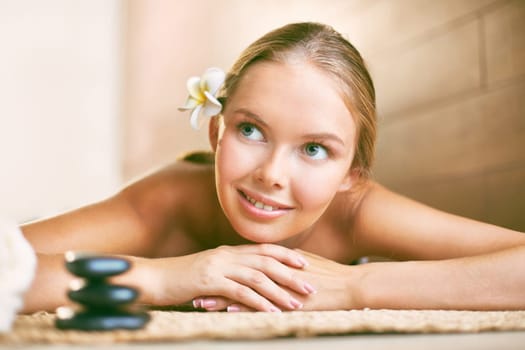 Smiling girl looking aside while relaxing in beauty salon