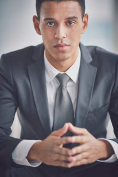 Serious businessman in formalwear looking at camera