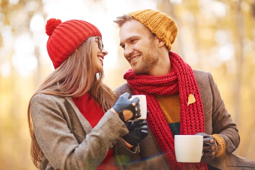 Cheerful couple having tea in natural environment