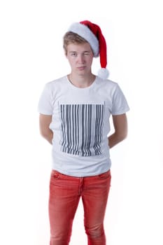 holiday portrait with a young caucasian male wearing a santa hat over a white background
