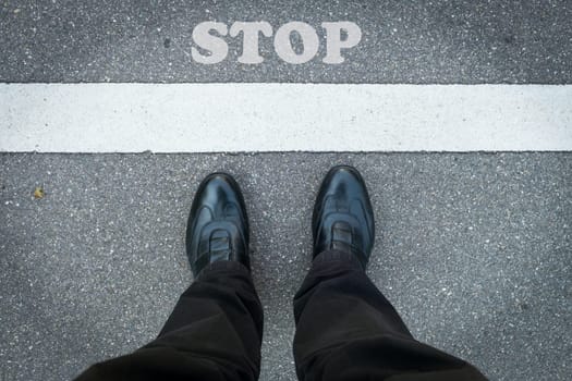 Feet employee with stop sign on the floor