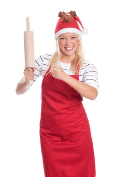 Woman with Christmas hat and apron holds a rolling pin