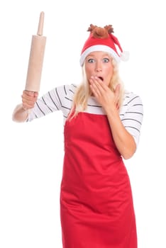 Christmas woman in apron holds a rolling pin and is terrified