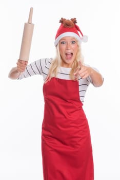Woman with Christmas hat and apron holds a rolling pin