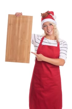 Christmas woman in apron points to a wooden board