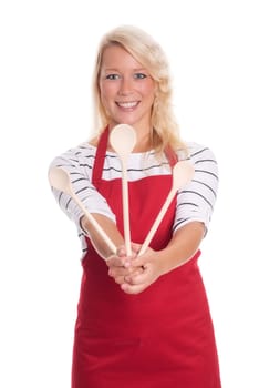 Housewife in apron holds various cooking spoons