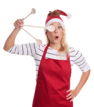 Christmas woman in apron holds cooking spoon in front of her eyes