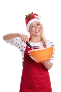 Woman with Christmas hat and apron stirs in a bowl