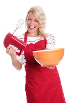 Woman in apron stirs with a blender in a bowl