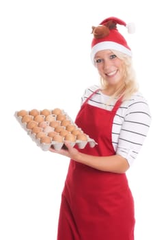 Woman with Christmas hat and apron holds a palette of eggs