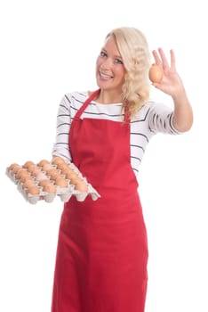 Woman with apron holds an egg palette and shows an egg