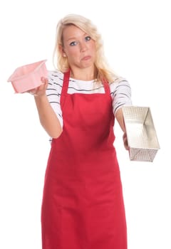Housewife in red apron shows different baking tins