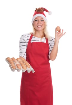 Woman with Christmas hat and apron holds a palette of eggs