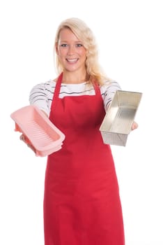 Housewife in kitchen apron keeps various baking tins
