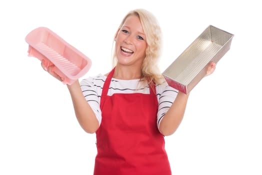 Housewife in kitchen apron keeps various baking tins