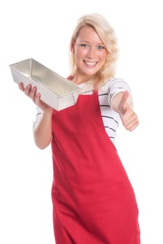 Housewife with apron holds a cake tin made of metal