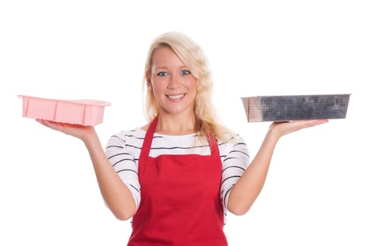 Housewife in kitchen apron keeps various baking tins