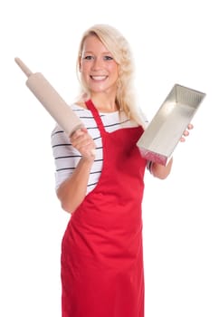 Young woman holds a baking tin and a rolling pin