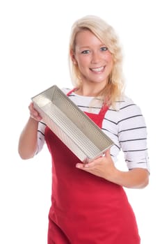 Housewife with apron holds a cake tin made of metal