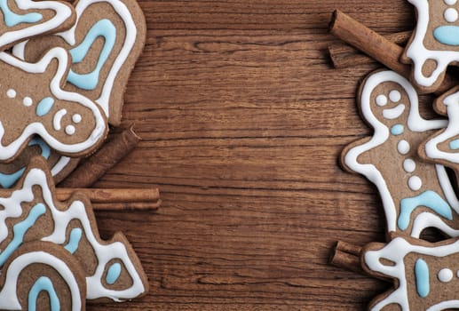 Tray of decorated gingerbread cookies with cinnamon sticks