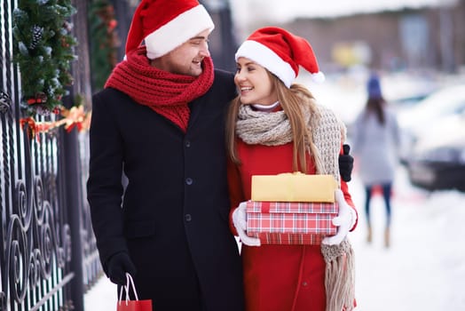 Couple of Santas with giftboxes going home on Christmas eve
