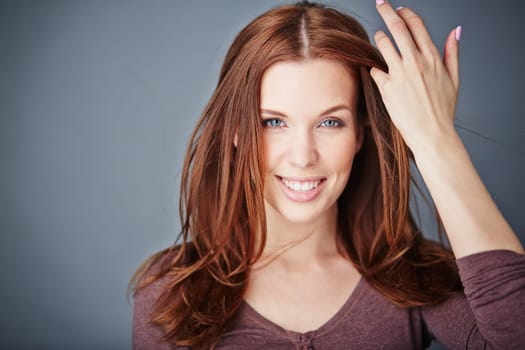 Young woman with long hair looking at camera with smile