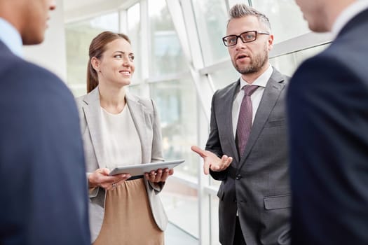 Confident colleagues discussing ideas at meeting in office