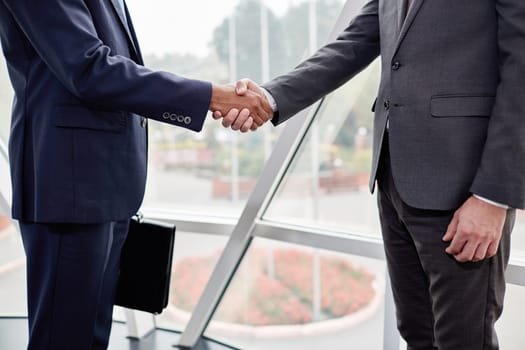 Hands of business partners during handshake