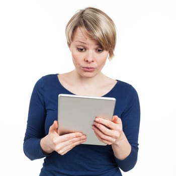 Young woman reading on an electronic tablet, isolated on white