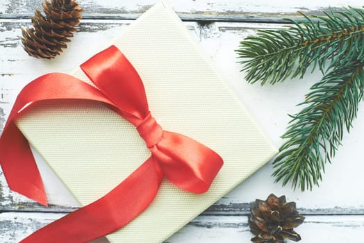 Composition made up of two cones, greeting card and coniferous branches