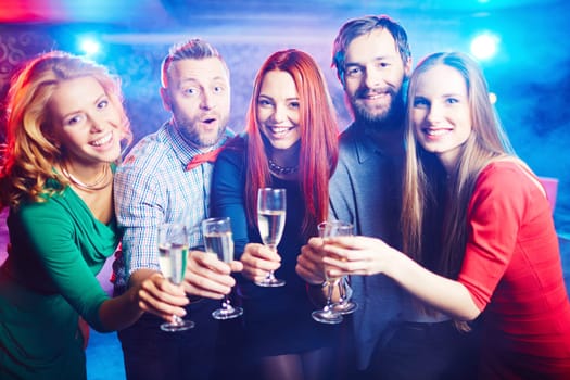 Group of ecstatic friends having party in night club