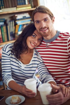 Amorous sweethearts sitting in cafe