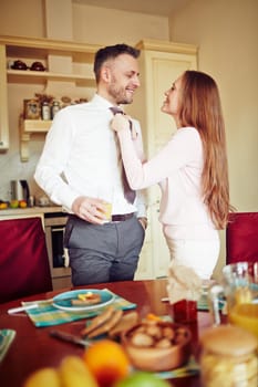 Married couple standing by table in the kitchen