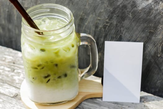 Iced green tea latte with blank name card, stock photo