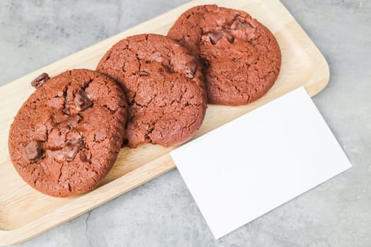 Homemade chocolate cookies with blank name card, stock photo