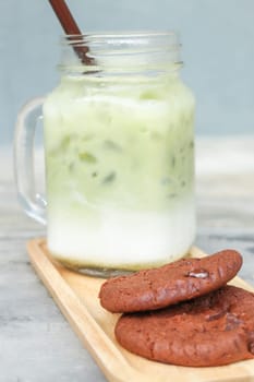 Iced green tea latte and chocolate cookies, stock photo