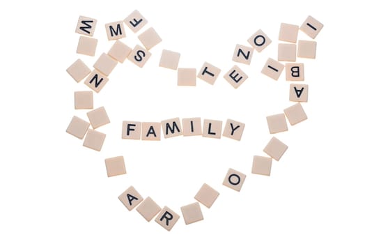 Small game tiles with letters on them arranged in a heart surrounding the word "love"" isolated on a white background."
