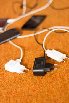Phone Chargers on the orange carpet floor