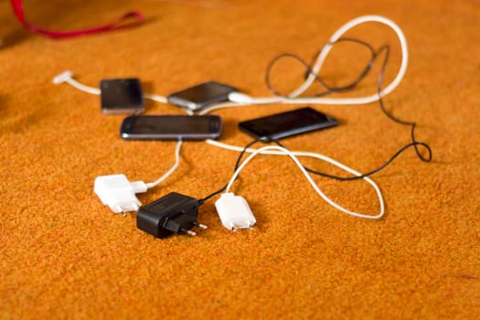 Phone Chargers on the orange carpet floor