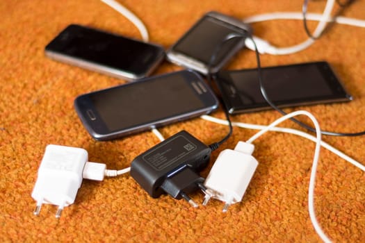 Phone Chargers on the orange carpet floor