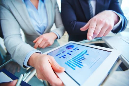 Employees with touchpad consulting about review of marketing