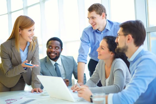 Pretty manager explaining her viewpoint upon project to co-workers