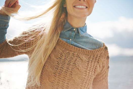 Blond girl with long hair and toothy smile showing satisfaction