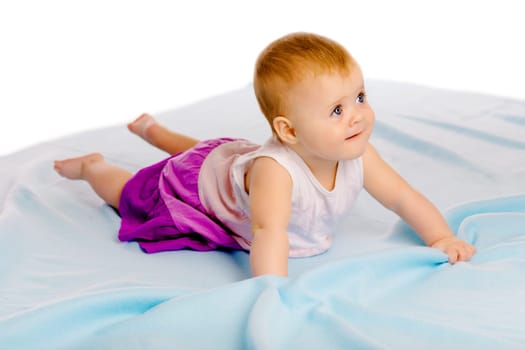 Charming baby girl in a dress. Studio