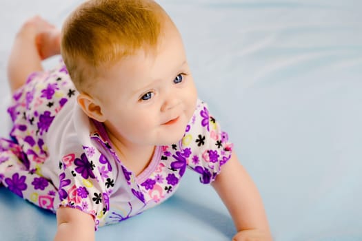 Charming baby girl in a dress. Studio
