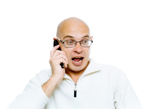 Bald man emotionally communicates by phone. Isolated on white. Studio