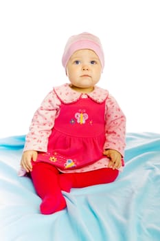 Little girl baby in a dress sitting on the floor